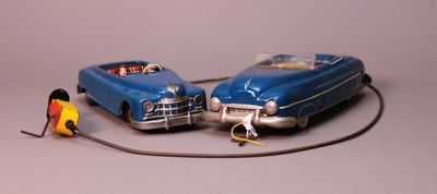 two toy cars sitting next to each other on a table