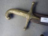 a gold sword with a wooden handle and a tag on it