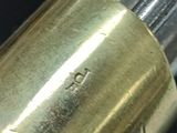 a close up of a gun with a brass plate on it
