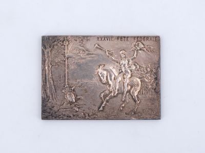 an image of a metal plaque depicting a man riding a horse
