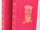 deux livres roses ornés de dorures, posés côte à côte