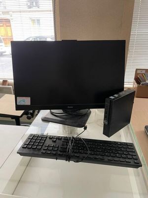 a computer desk with a keyboard and monitor on it