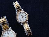 two watches that are sitting next to each other on a table