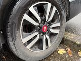 a close up of a car ' s tire on the street
