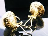 a pair of earrings that are sitting on a table