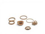 a lot of gold rings on a white surface