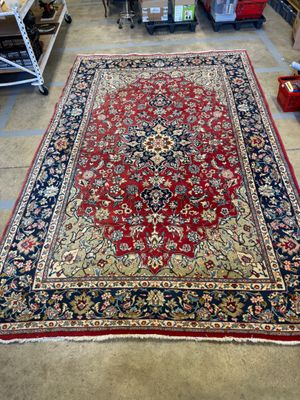 un tapis rouge et bleu dans un magasin où une étagère regorge d'autres articles