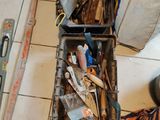 a box full of tools on the floor of a room