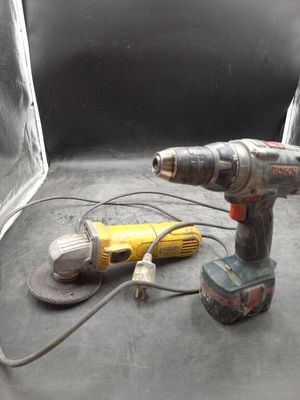 a corded drill and a power drill on a table