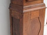 an old wooden grandfather clock sitting on the floor