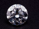 a close up of a diamond on a black surface