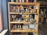a wooden shelf with various items on it in a room