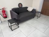 an image of a living room with a couch and fire extinguisher