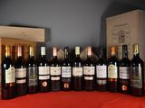 many bottles of wine sitting on a table next to a box of wine