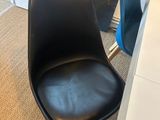 a black chair sitting in front of a white desk