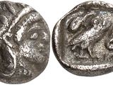 a silver coin with an image of a horse on it