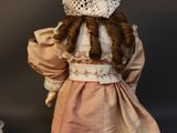 two antique dolls of a girl and a doll of a boy