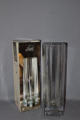a glass vase and a box on a table