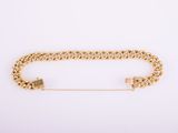 a gold chain bracelet with a lock on a white background