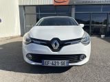 the front of a white car parked in front of a building