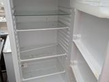 a white refrigerator with its door open in a kitchen