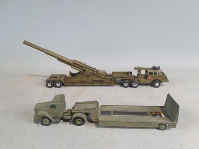 two toy army vehicles and a truck with a gun on the back