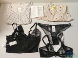 three lingersuits and a bra top on a table