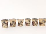 four shot glasses with a picture of a man and a woman on horseback