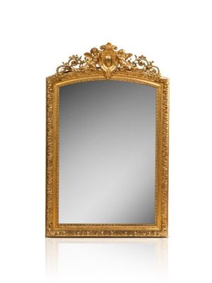 an ornate gold mirror with a white background and reflection