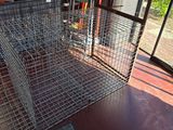a metal cage on the floor next to a window