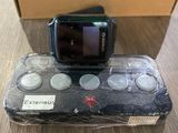 a cell phone that is sitting on top of a game controller