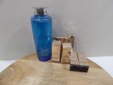 a bottle of blue liquid sitting on a table next to a box of soap