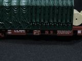 a green train car with a lot of people on it