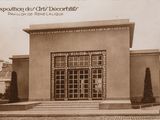 an old photo of a building with a large glass door