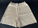 the bottom of a pair of white shorts on a black surface