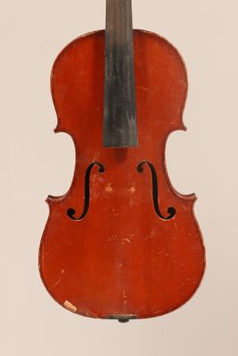 un vieux violon posé sur une surface blanche