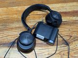 a pair of headphones sitting on top of a wooden table