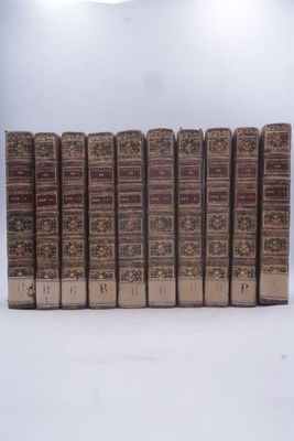 plusieurs vieux livres sont alignés sur une surface blanche