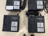 four batteries and a charger are sitting on a table