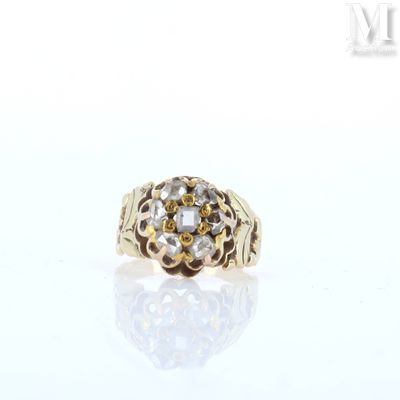 a close up of a gold ring with diamonds on a white surface