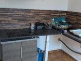 a kitchen with a sink, stove, and a stove top oven