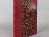 a red book with a floral design on the cover