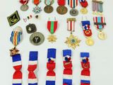 an assortment of medals and medals are displayed on a white surface