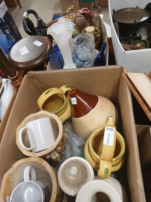 many cups and saucers in a box on the floor