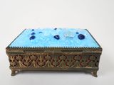 a blue glass box sitting on top of a table