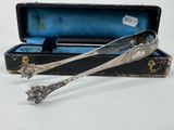 two spoons sitting in a box on a table
