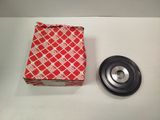 a red and white box sitting on top of a table next to a metal object