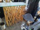an image of a bar with a glass top and a stool