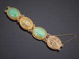 a gold and jade bracelet