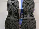 the back of a pair of black shoes on a white surface